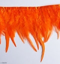 Close-up of orange natural rooster feather fringe trim.