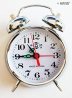 Side view of the gold alarm clock showing the dial