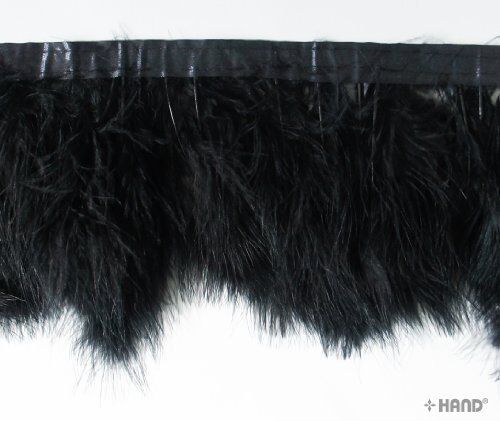 Black goose feather fringe trim displayed on a wooden surface.