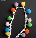 Close-up of colourful pom pom trim showing 13mm pom poms