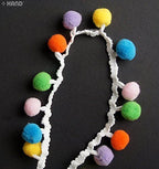 Close-up of colourful pom pom trim showing 13mm pom poms