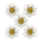 Three layers of white enamel and brass flower trim on a white background.