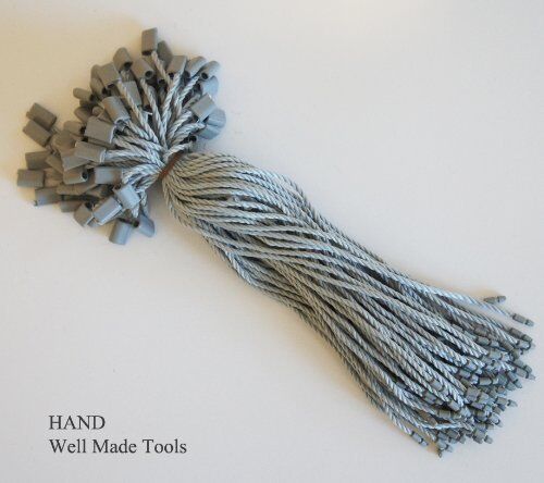 Close-up of nylon string round snap lock hang tags for crafting.