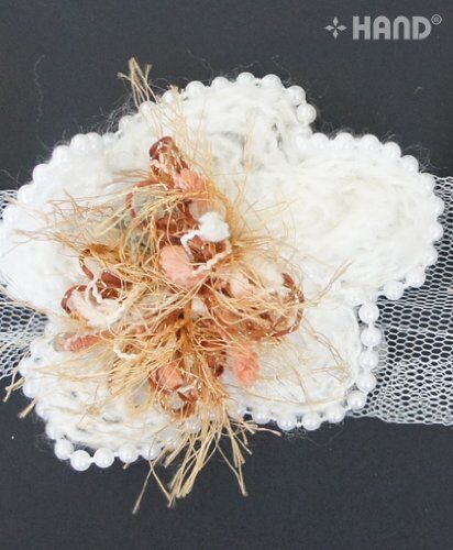 Close-up of colourful centre of the knitted flower trim