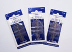 Close-up of nickel plated steel sewing needles with sharp points.