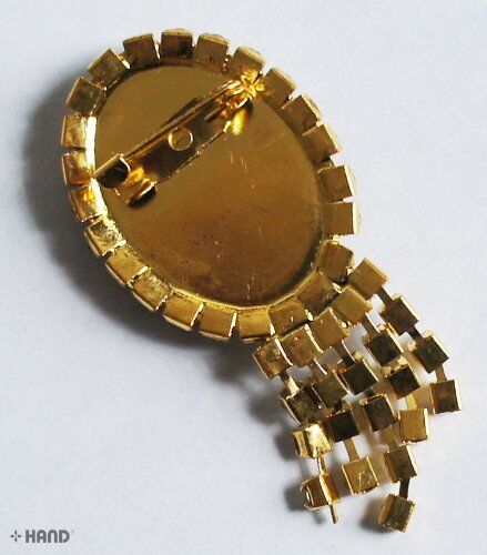 Elegant small brooches arranged together to highlight their design.