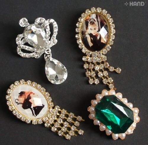 Four assorted vintage brooches displayed on a neutral background.