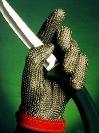 Glove being worn while using a rotary cutter in a fashion studio.