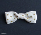 Craft project using cream ribbon bows with brown dots.