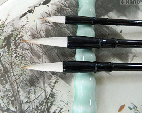 Small Sumi brush displayed on a wooden surface