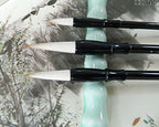 Small Sumi brush displayed on a wooden surface