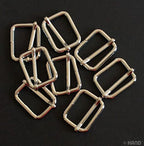 Silver tone metal sliders displayed in a neat arrangement.
