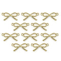 Gold colour ribbon bow pendant on a white background.
