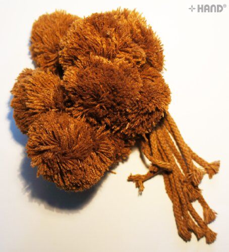 Close-up of a 50mm brown pom pom with attached string.