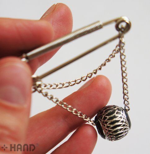 Display of 50mm silver kilt pins arranged neatly