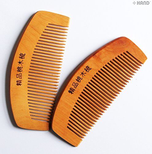 Close-up of the dual head design of the wooden hair comb.