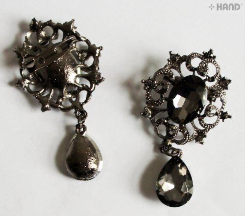 Elegant stone brooch displayed on a neutral background