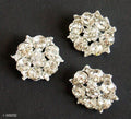 Small silver brooch with clear crystals, elegant design.