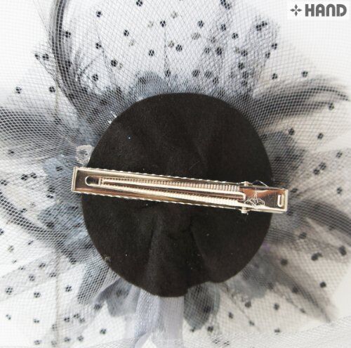 Metal clip detail on a flower net feather accessory