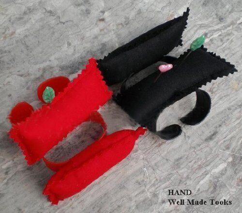 Two finger pin cushions in use, securely holding pins for sewing.
