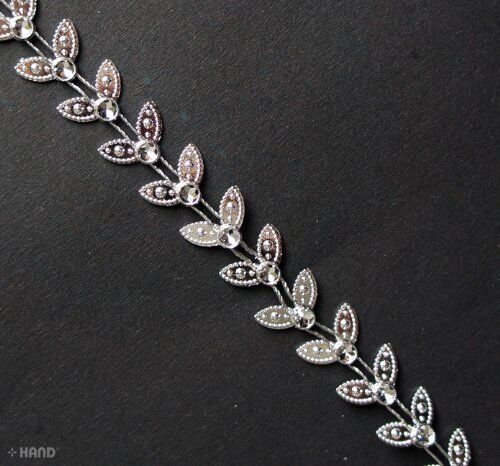 LEAF3 silver leaves trim displayed with other craft supplies.