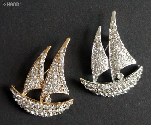 Clear crystal boat brooch on a fabric background