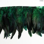 Close-up of emerald green rooster feathers stitched onto a trim.