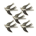 Five silver colour swallow pendants for jewellery making.
