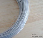 Roll of icy silver plastic coated craft wire, 1.5 mm thick.