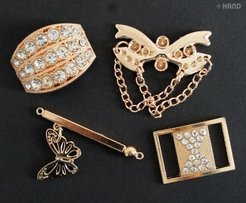 Variety of gold tone DIY accessories with Diamote gems on a craft table.