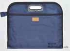 Side view of the navy blue nylon portfolio showcasing its thickness