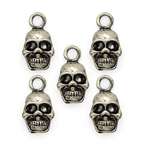 Silver skull pendants displayed on a crafting surface.