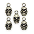 Five silver metal skull pendants for jewellery making.
