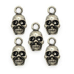 Five silver metal skull pendants for jewellery making.