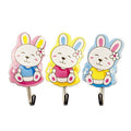Three colourful baby bunny rabbit adhesive hooks for nursery use.