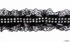 Close-up of black lace ribbon showing diamante details