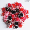 Assorted colours of F14 decorative flower trims displayed