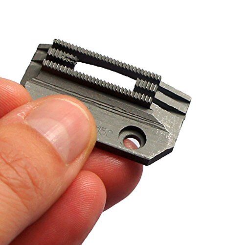 Close-up of the fine teeth on the sewing machine feed dog