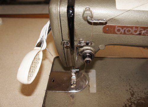 Flexible gooseneck lamp positioned over a sewing project