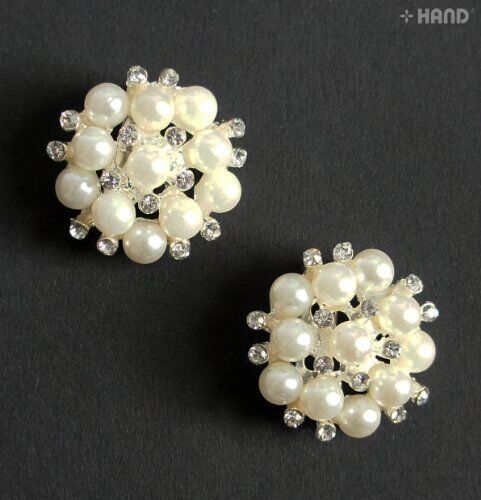 Two small pearl and clear crystal brooches displayed on a white background.