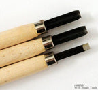 Close-up of the blade of a woodcarving chisel showcasing its sharp edge.