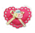 Pack of 10 bright pink heart-shaped trims with ribbon flowers.