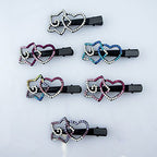 Close-up of black hair clips featuring vibrant crystal designs.