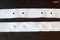 Close-up of 10 metres push button tape in white, 18mm wide.