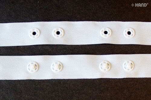 Close-up of 10 metres push button tape in white, 18mm wide.