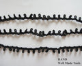 Black nylon loop trim displayed on a white background