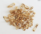 Small gold zip pulls displayed on a white background