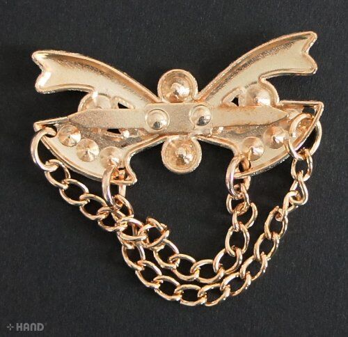 Close-up of a gold tone embellishment featuring sparkling Diamote gems.