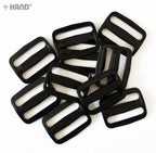 Close-up of a black webbing slide buckle measuring 44 mm.