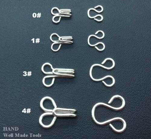 Silver hook and eye fasteners, size 4, in a pack of approximately 250 sets.